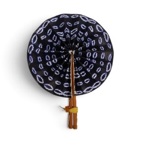 Éventail rond Dozeko en tissu wax bleu indigo à motifs blancs, doté de manches en simili cuir marron.